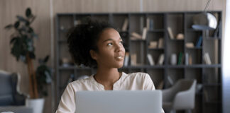 What Ugandans Really Think About Online Shopping This Year Ugandan using a laptop for online shopping, highlighting local e-commerce opinions.